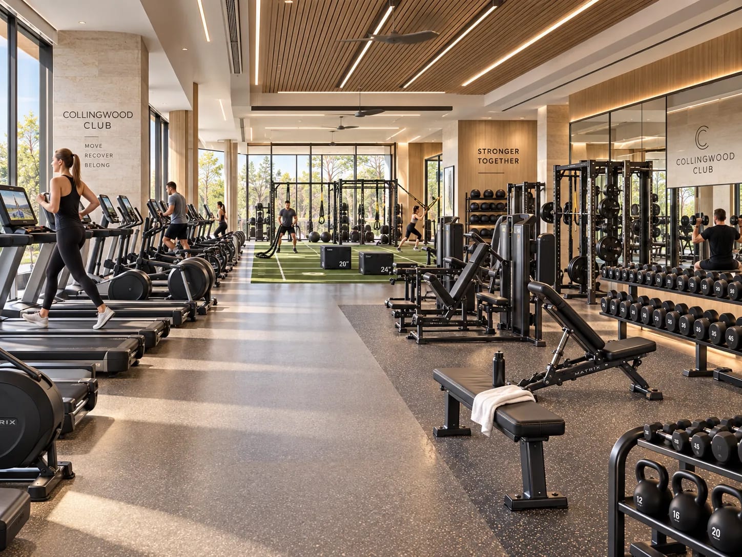 Cardio machines along the windows, free weights behind them and a turf strip at the back for training and rehab work.